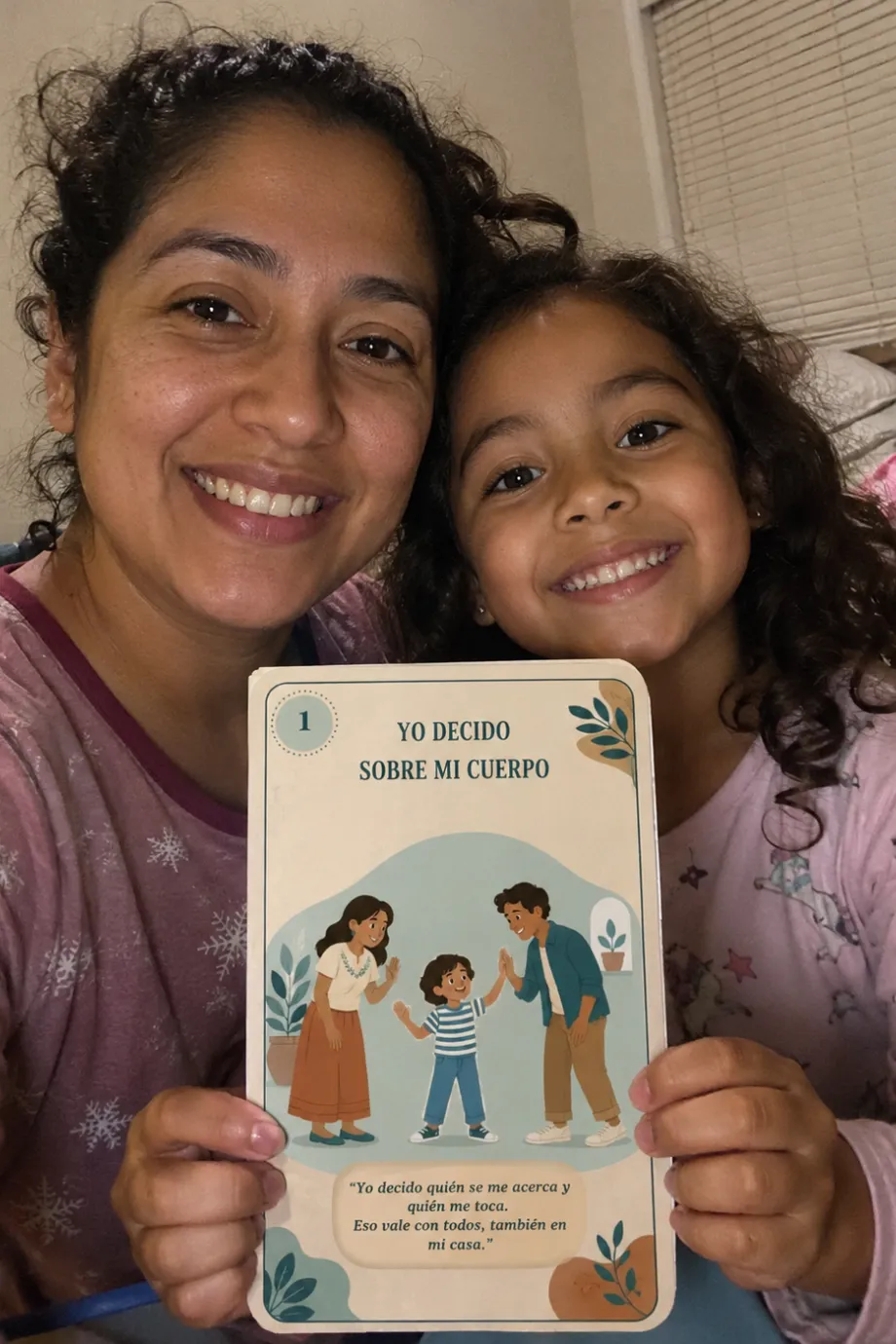 Una mamá y su hija leyendo la tarjeta «Yo decido sobre mi cuerpo»